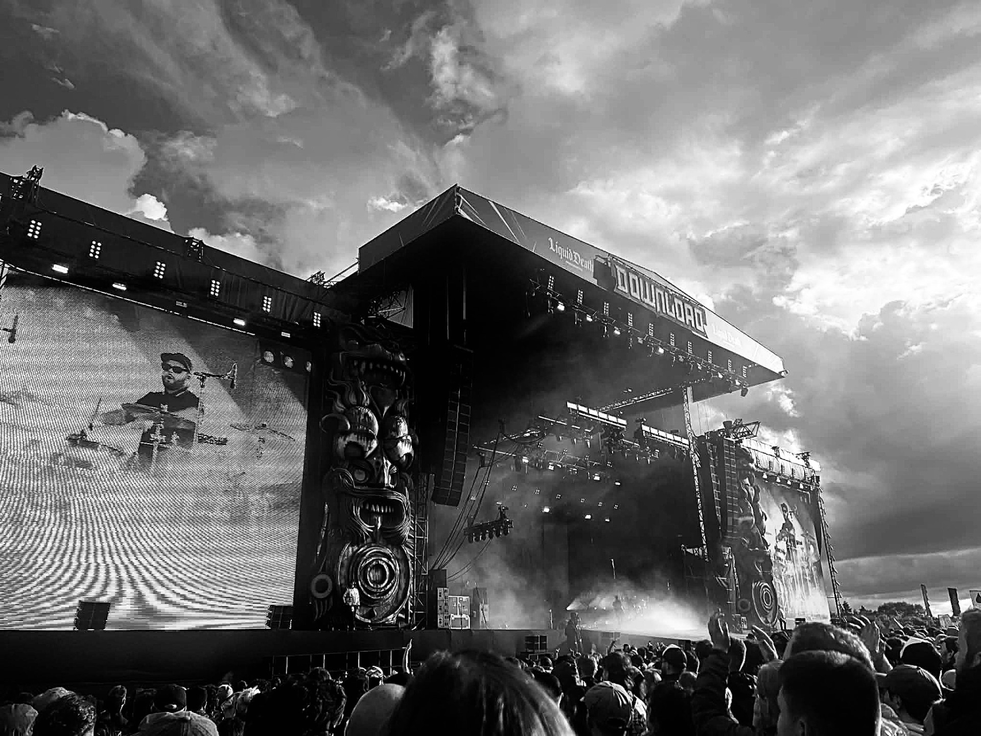 Download Festival main stage with skull-carved screens under a dramatic sky